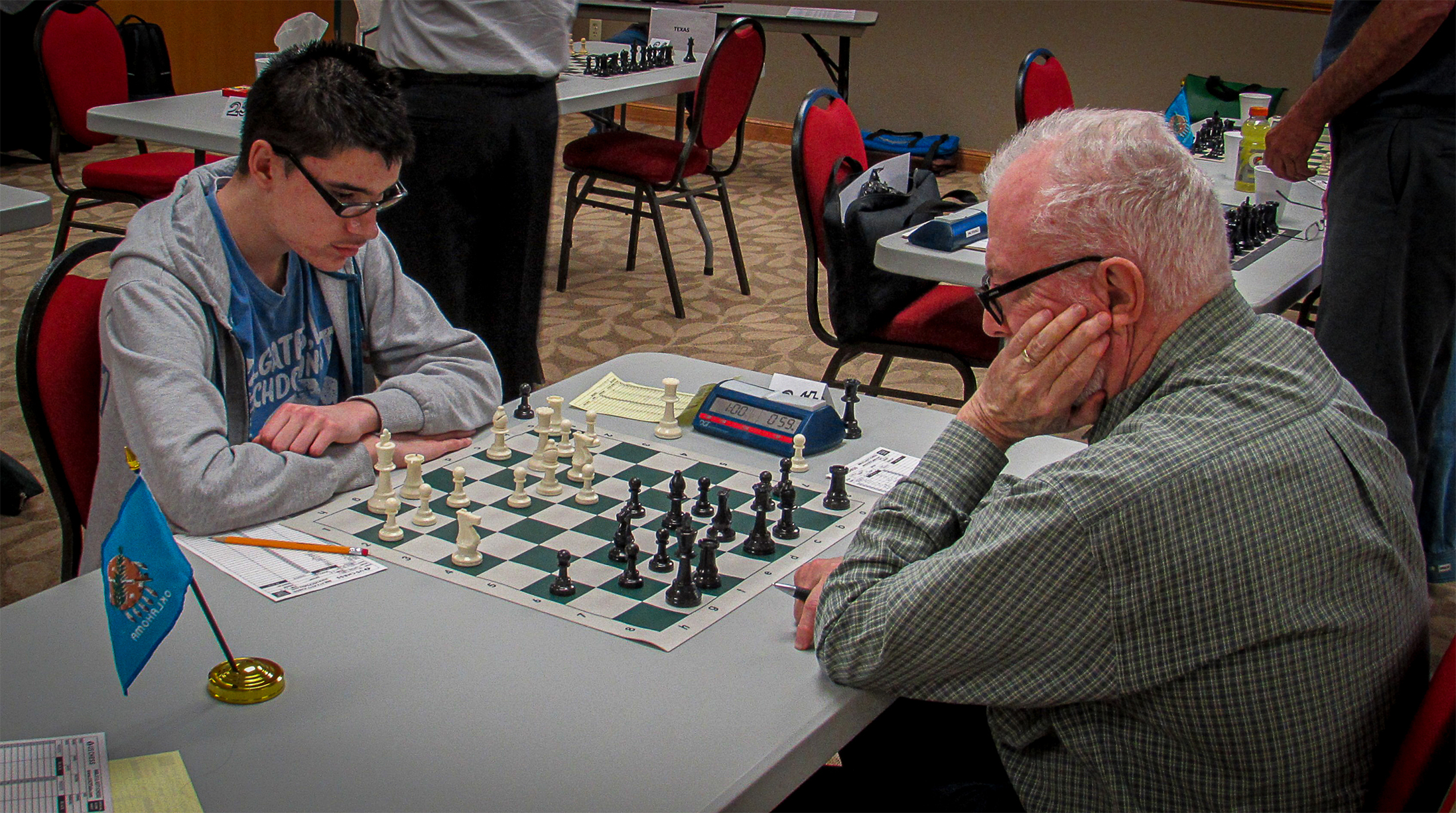 Lawton's Jayden Dewbre (left) and Tishmingo's Roy Cram (a US Chess Life Member) do battle.  Photo by Mike Tubbs.
